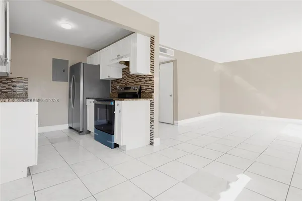 a kitchen with stainless steel appliances a refrigerator and a stove