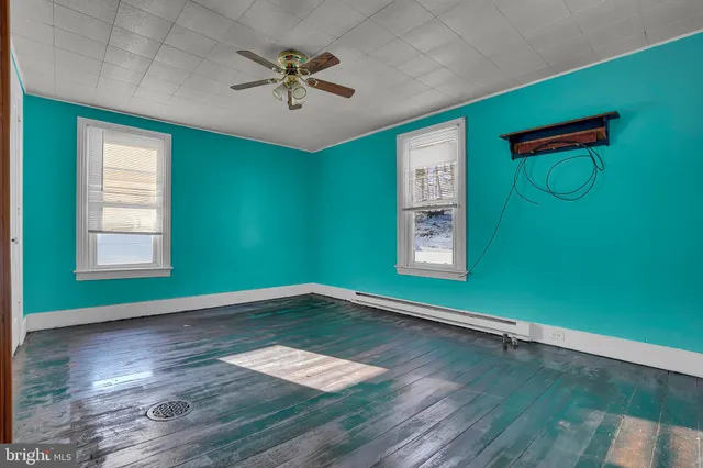 a view of a house with snow on the side of road