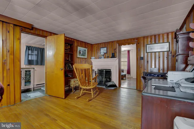 a living room with furniture ceiling fan and a large window