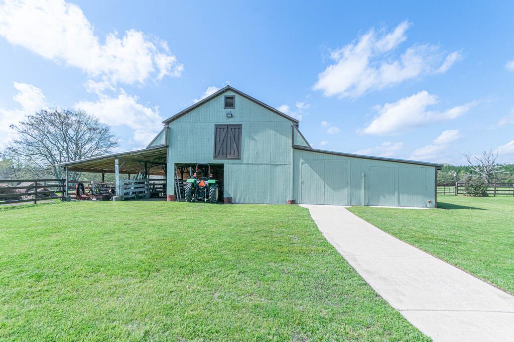193 Padgetts Road Seale, AL 36875 - Photo 25 of 49 a front view of a house with a yard and garage