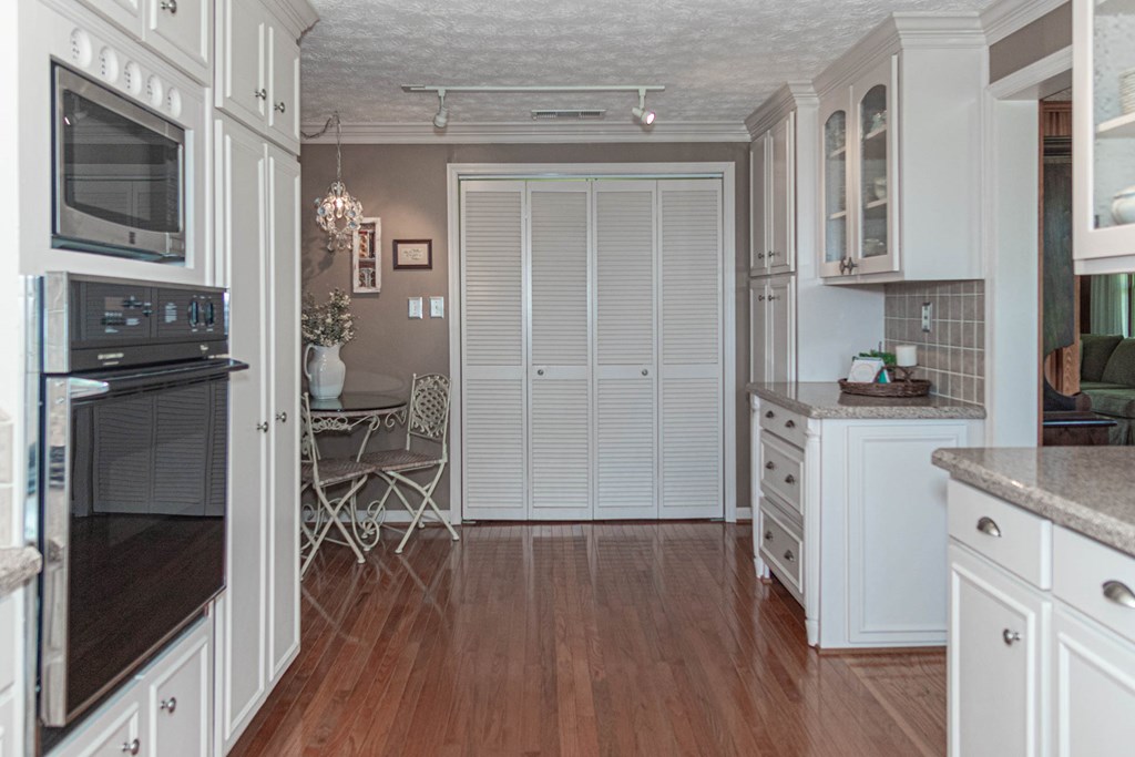 193 Padgetts Road Seale, AL 36875 - Photo 3 of 49 a kitchen with cabinets and wooden floor