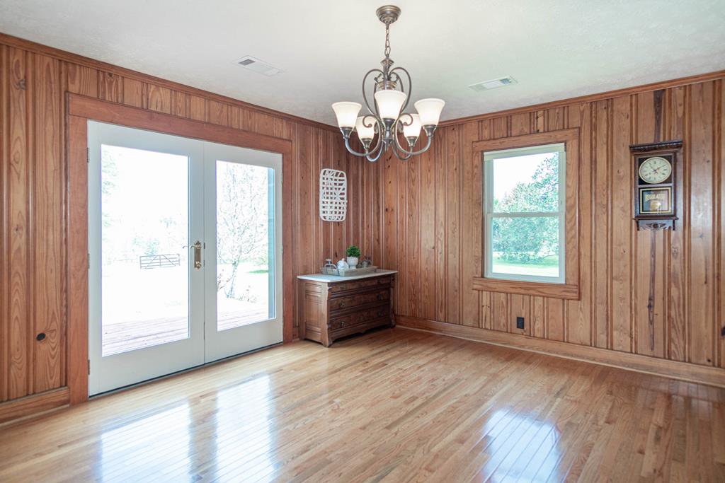 193 Padgetts Road Seale, AL 36875 - Photo 7 of 49 a view of an empty room with wooden floor and a window