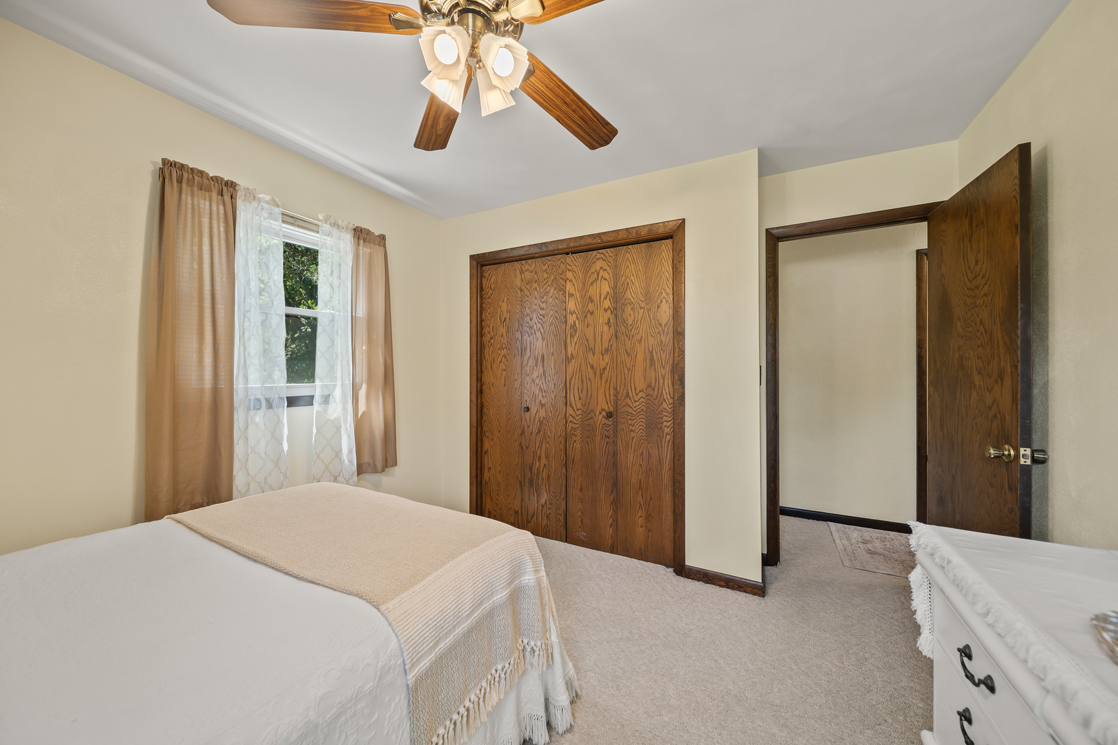 24146 Stage Coach Road Geneseo, IL 61254 - Photo 15 of 39 a bedroom with a bed and a chandelier