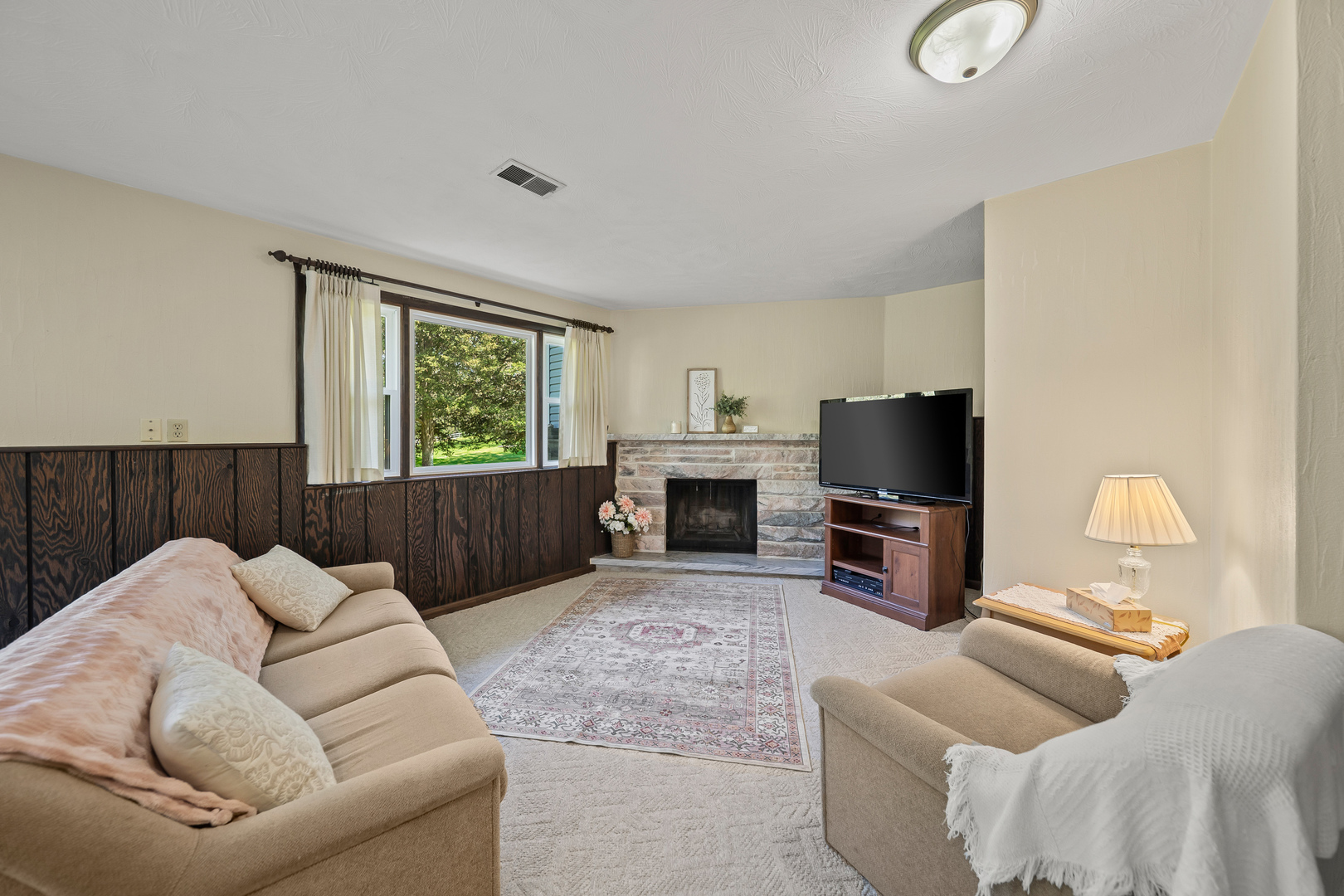 24146 Stage Coach Road Geneseo, IL 61254 - Photo 22 of 39 a living room with furniture a fireplace and a flat screen tv