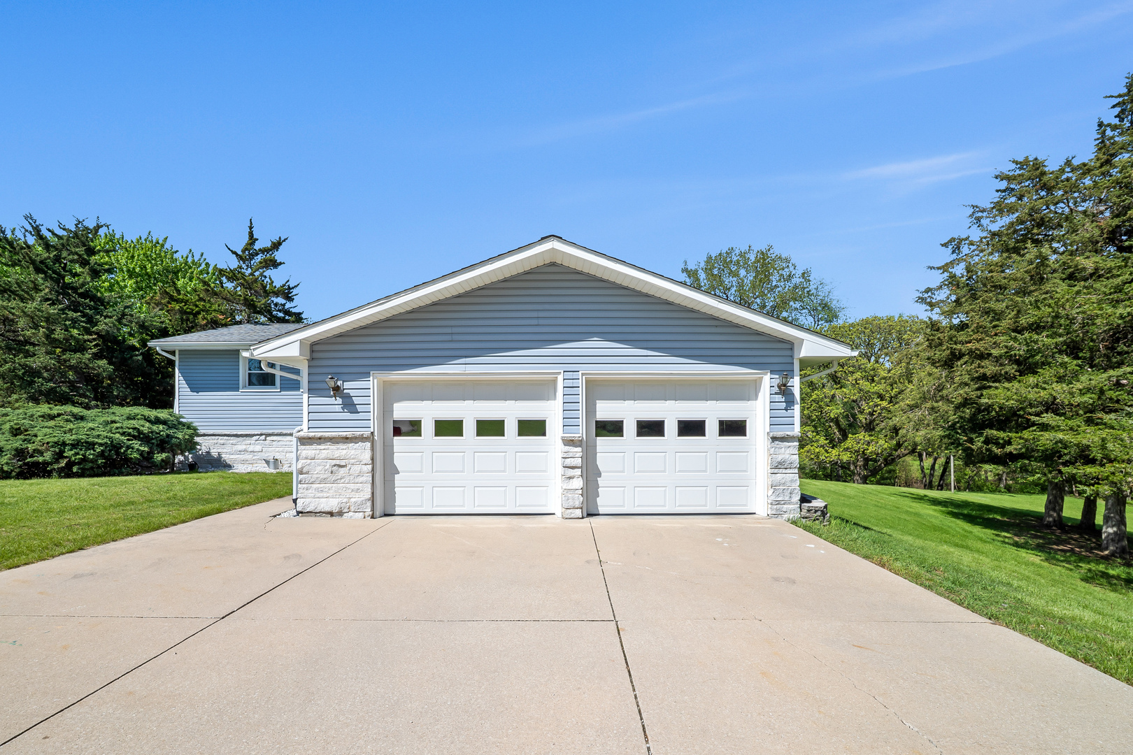 24146 Stage Coach Road Geneseo, IL 61254 - Photo 3 of 39 a front view of a house with a yard and garage