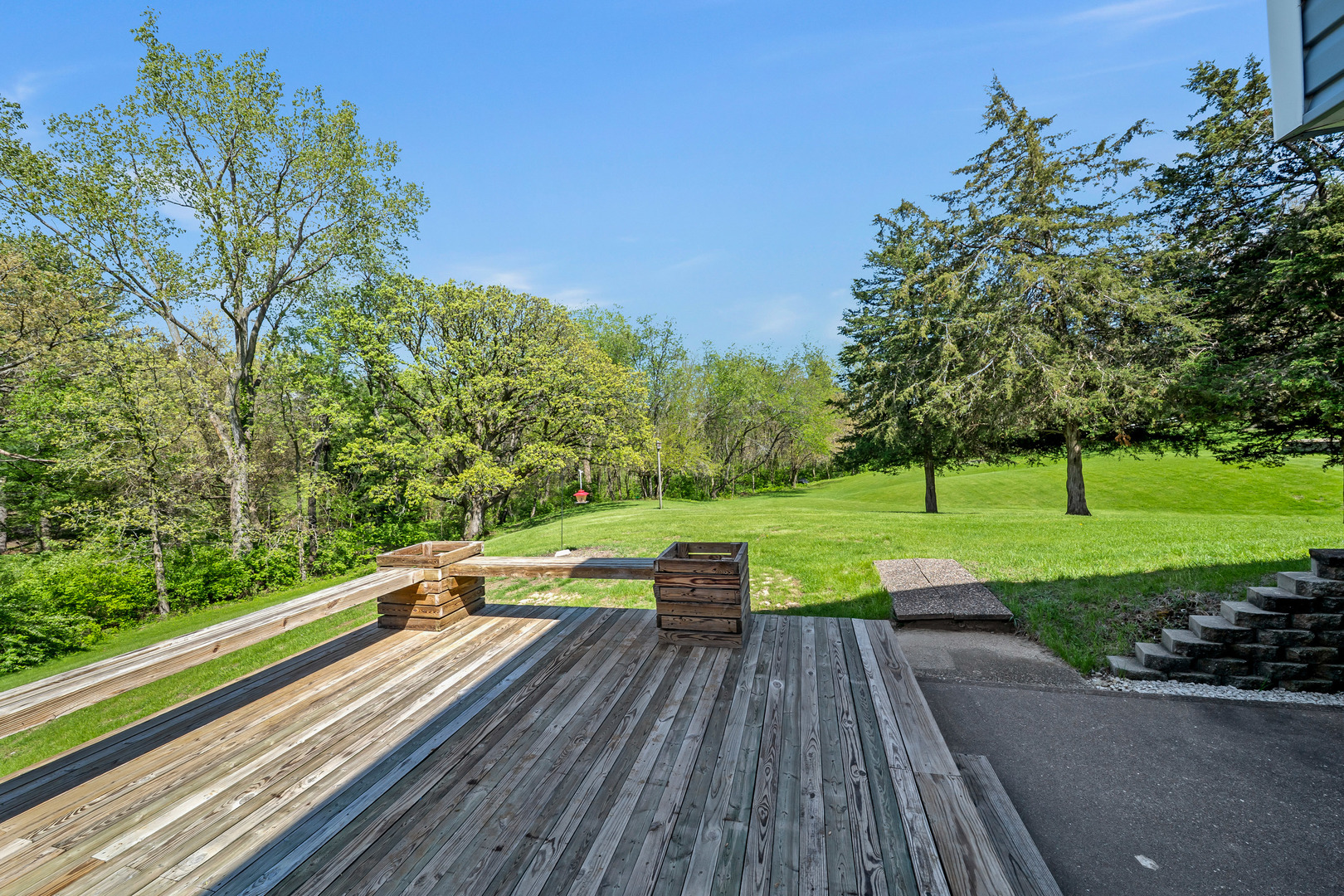 24146 Stage Coach Road Geneseo, IL 61254 - Photo 31 of 39 a view of house with deck outdoor seating and trees in the background