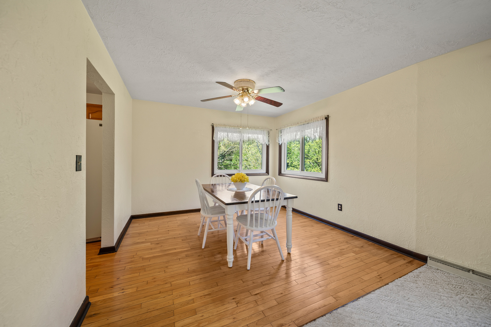 24146 Stage Coach Road Geneseo, IL 61254 - Photo 9 of 39 a dining room with chandelier and wooden floor