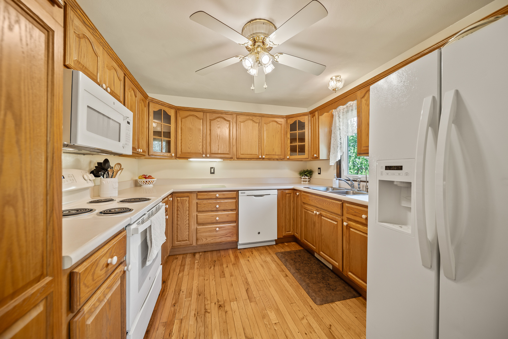 24146 Stage Coach Road Geneseo, IL 61254 - Photo 10 of 39 a kitchen with stainless steel appliances a stove a sink cabinets and a window
