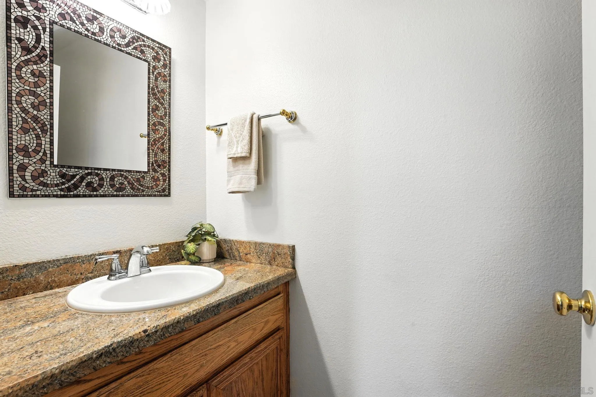 29581 Cara Way Temecula, CA 92591 - Photo 12 of 24 a bathroom with a granite countertop sink and a mirror