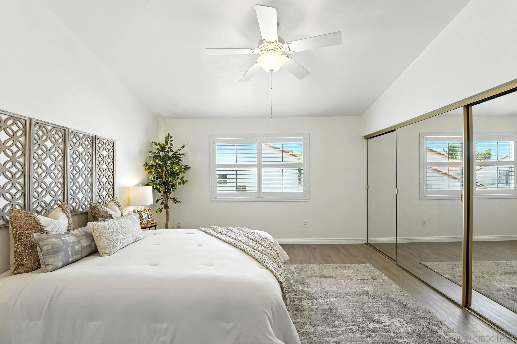 29581 Cara Way Temecula, CA 92591 - Photo 13 of 24 a bedroom with a large bed and a chandelier