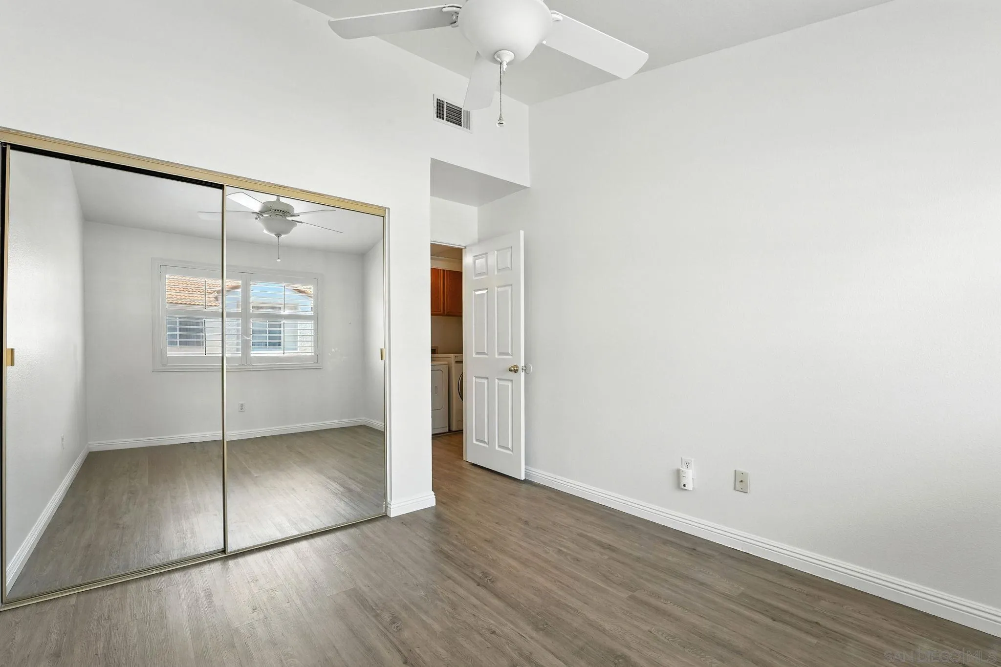 29581 Cara Way Temecula, CA 92591 - Photo 16 of 24 an empty room with wooden floor and windows