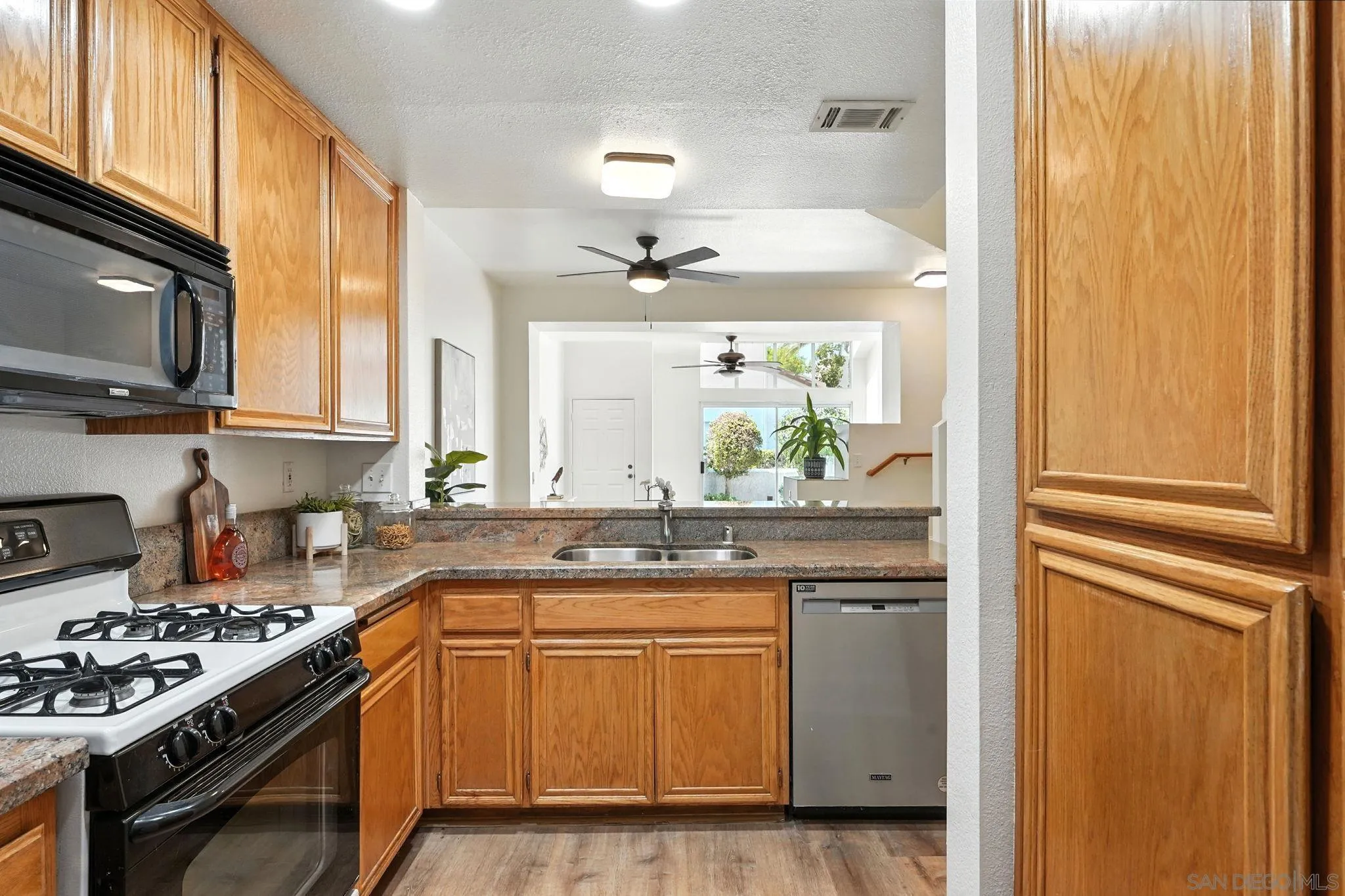 29581 Cara Way Temecula, CA 92591 - Photo 9 of 24 a kitchen with a sink stove and microwave