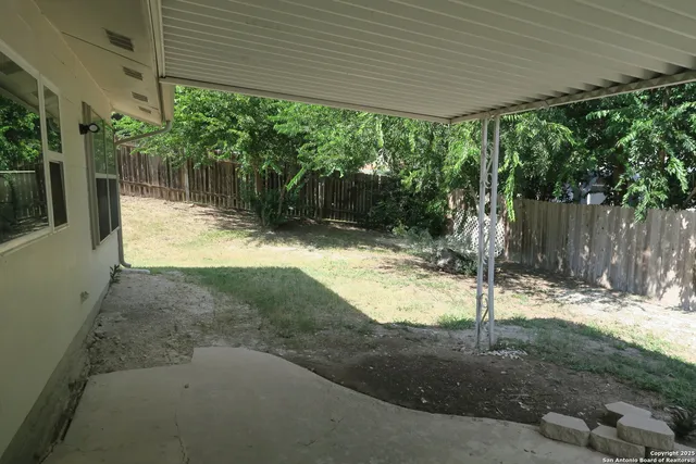 a backyard of a house with a tree