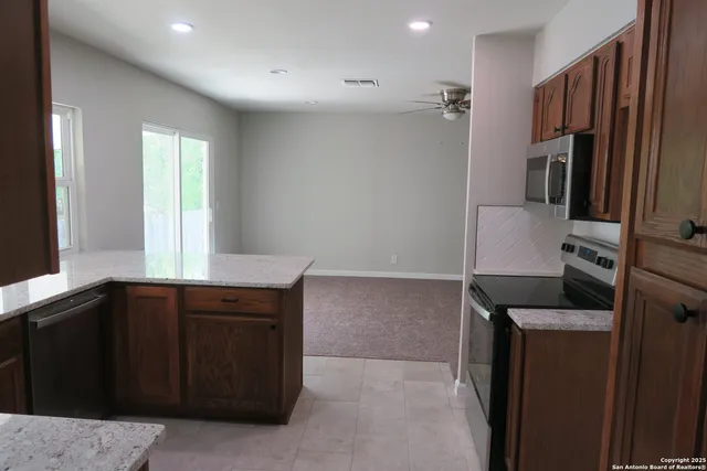 a kitchen with a refrigerator and a sink