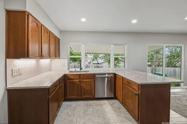 a kitchen with a sink and large window
