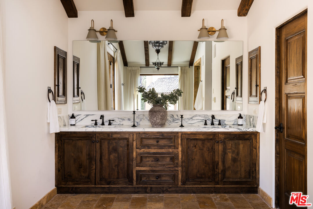 7935 Oceanus Drive Los Angeles, CA 90046 - Photo 23 of 43 a bathroom with a double vanity sink and mirror