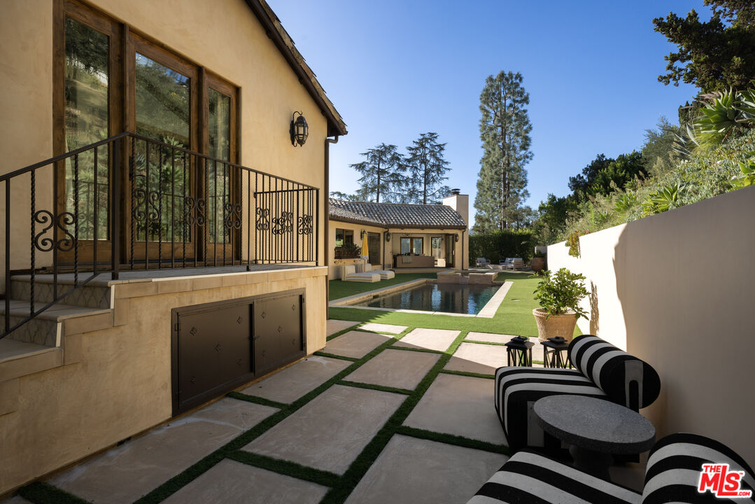 7935 Oceanus Drive Los Angeles, CA 90046 - Photo 36 of 43 a view of a patio with a table chairs and a potted plant