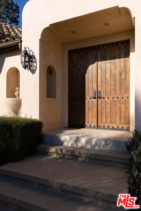 7935 Oceanus Drive Los Angeles, CA 90046 - Photo 7 of 43 a bedroom with a bed and a large window