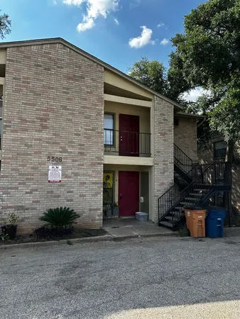 a view of a brick house with an outdoor space