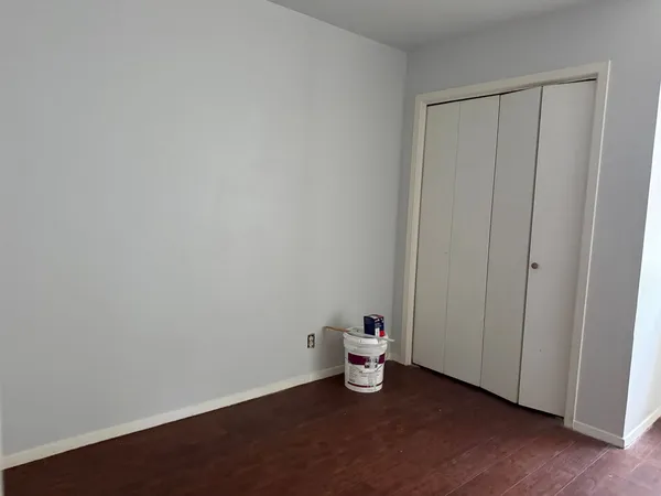 a view of a room with wooden floor
