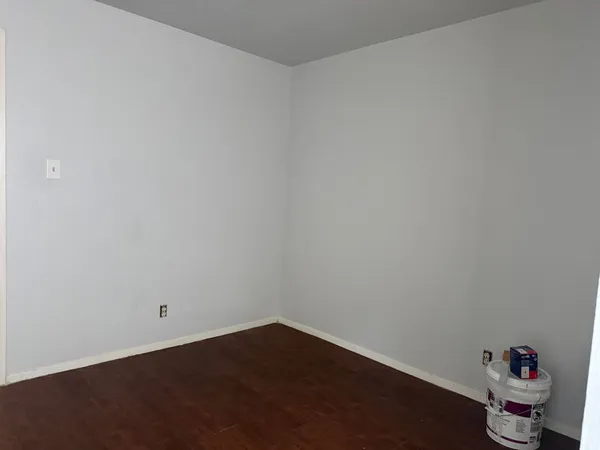 a room with a hard wood floor and a sink
