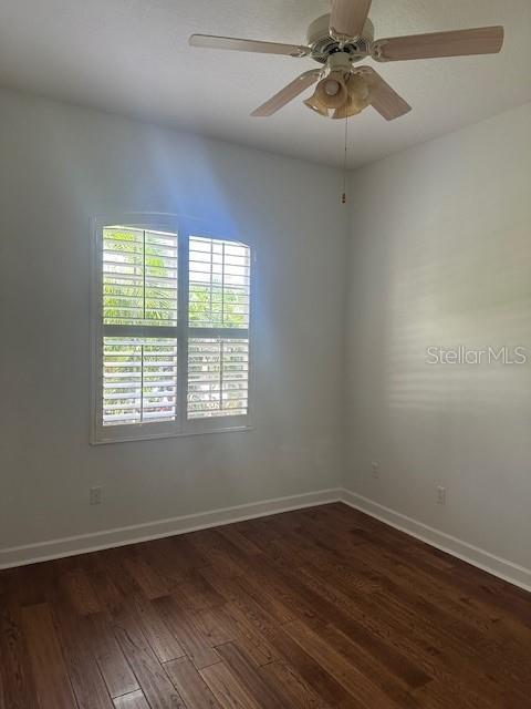 10228 Silverado Circle Lakewood Ranch, FL 34202 - Photo 15 of 20 a view of an empty room with wooden floor and a window