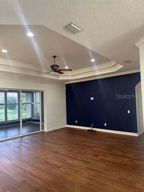10228 Silverado Circle Lakewood Ranch, FL 34202 - Photo 4 of 20 a view of an empty room with wooden floor and a ceiling fan