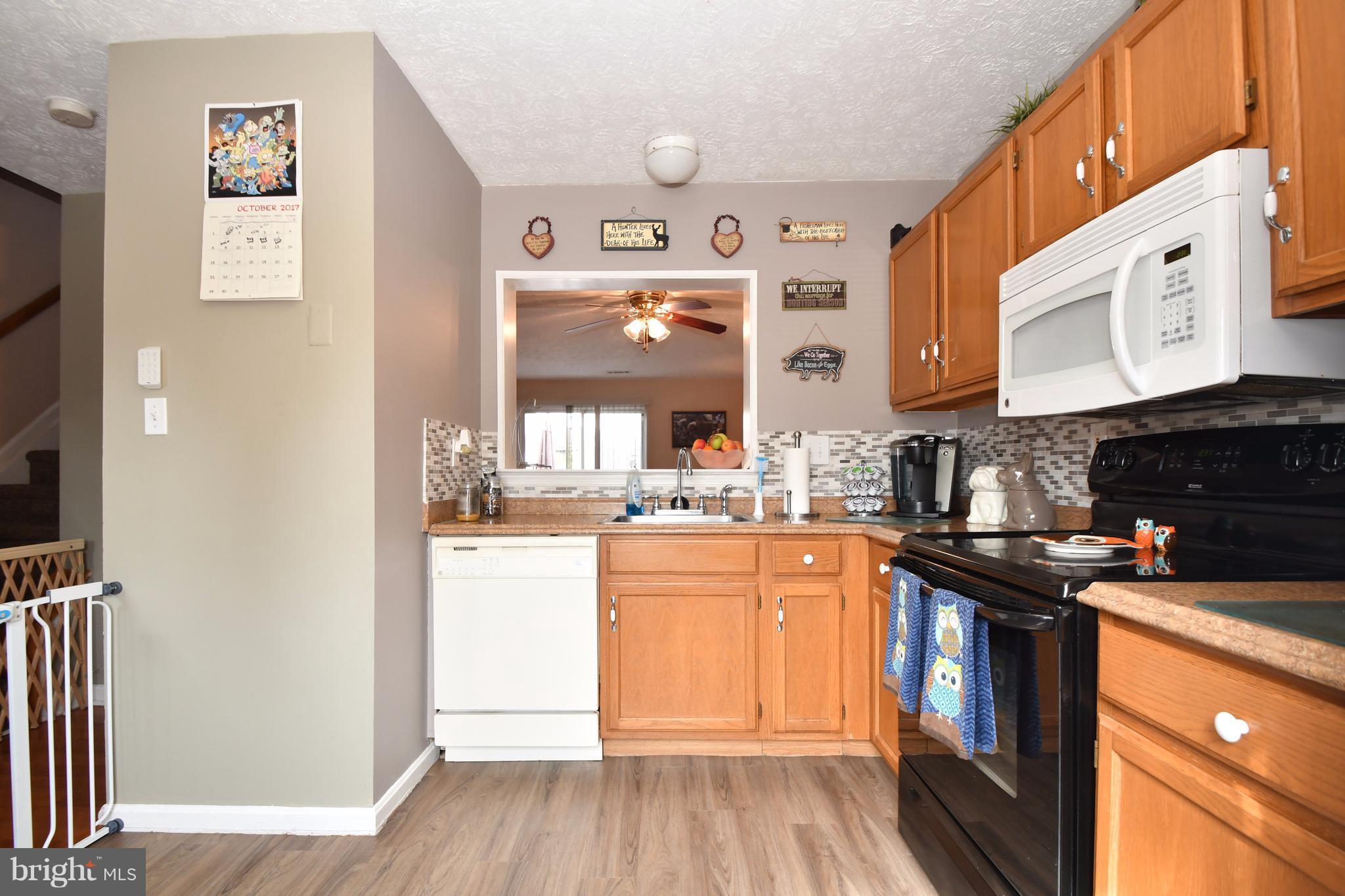 3924 Cutty Sark Road Baltimore, MD 21220 - Photo 2 of 30 a kitchen with stainless steel appliances granite countertop a stove and a refrigerator