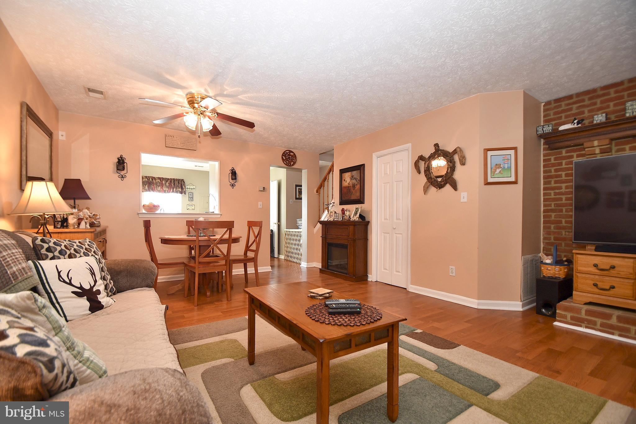 3924 Cutty Sark Road Baltimore, MD 21220 - Photo 12 of 30 a living room with furniture a flat screen tv and kitchen view