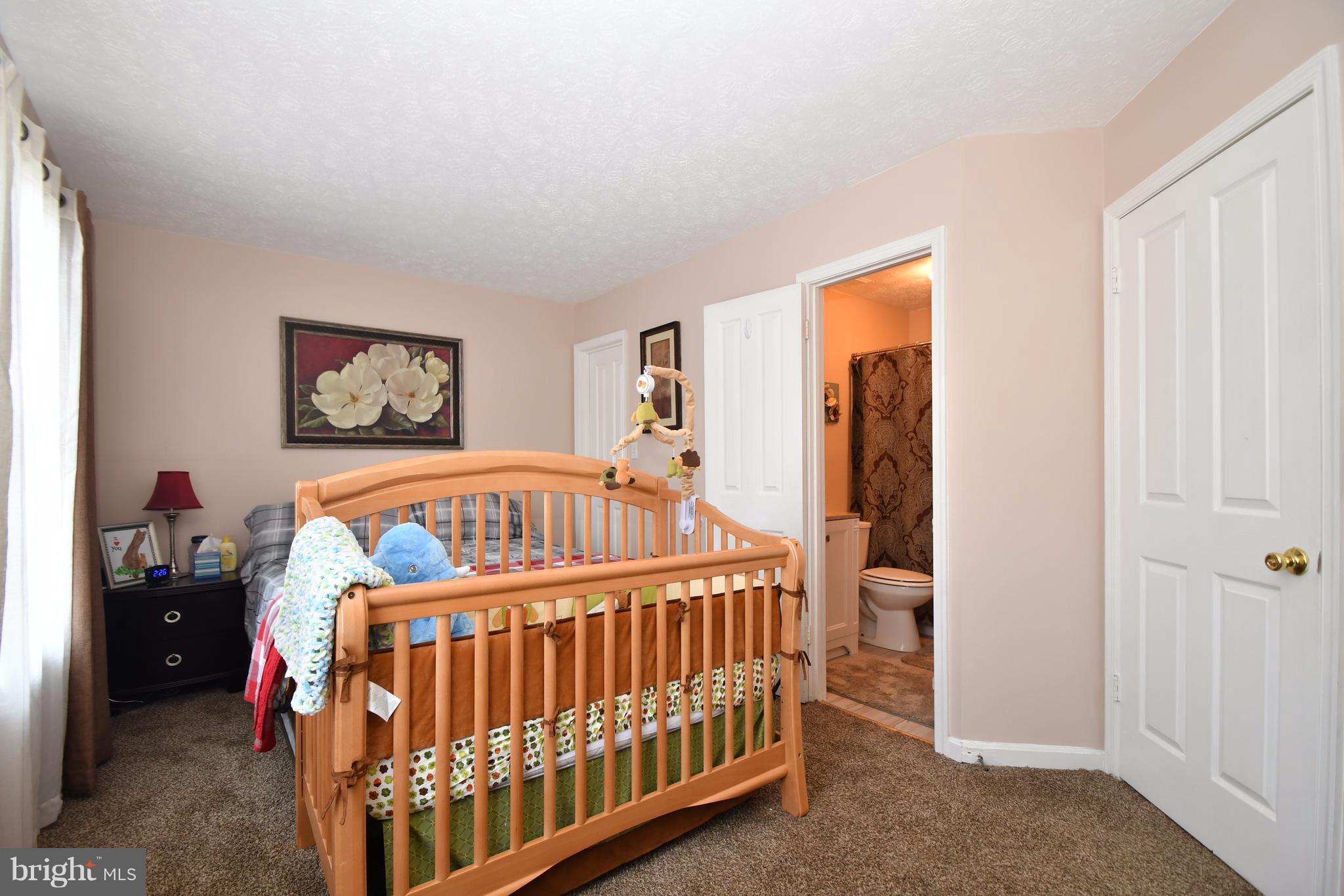 3924 Cutty Sark Road Baltimore, MD 21220 - Photo 16 of 30 a bedroom with furniture and a baby crib