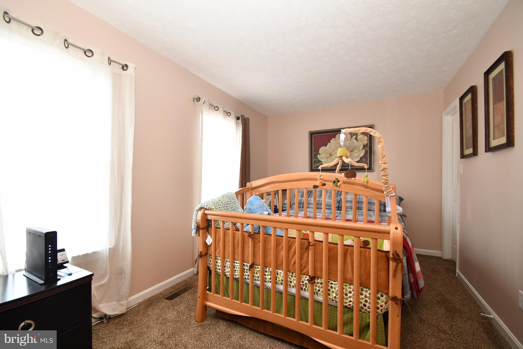 3924 Cutty Sark Road Baltimore, MD 21220 - Photo 17 of 30 a bedroom with a bed and wooden floor