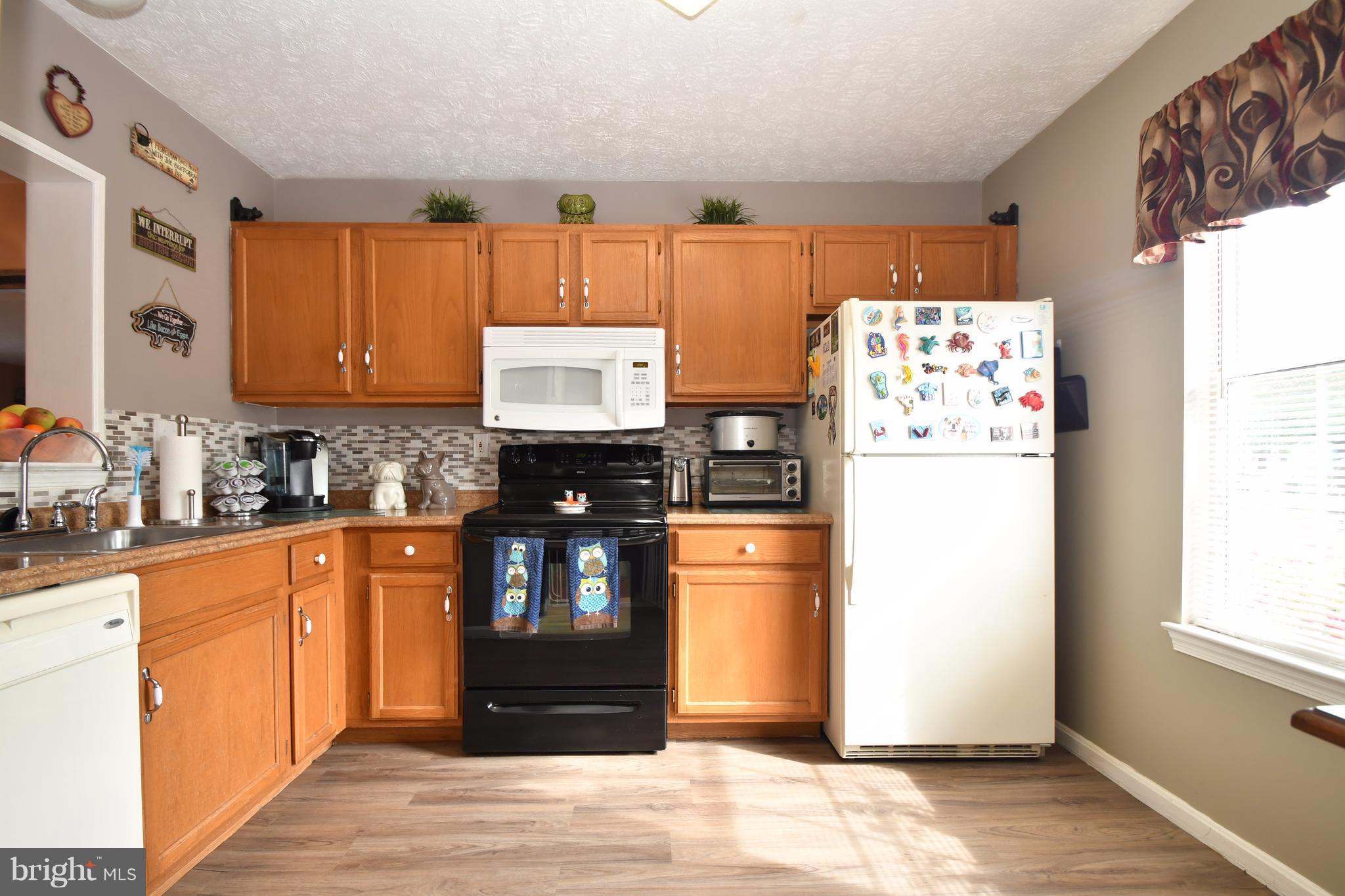 3924 Cutty Sark Road Baltimore, MD 21220 - Photo 3 of 30 a kitchen with stainless steel appliances granite countertop a refrigerator and a sink