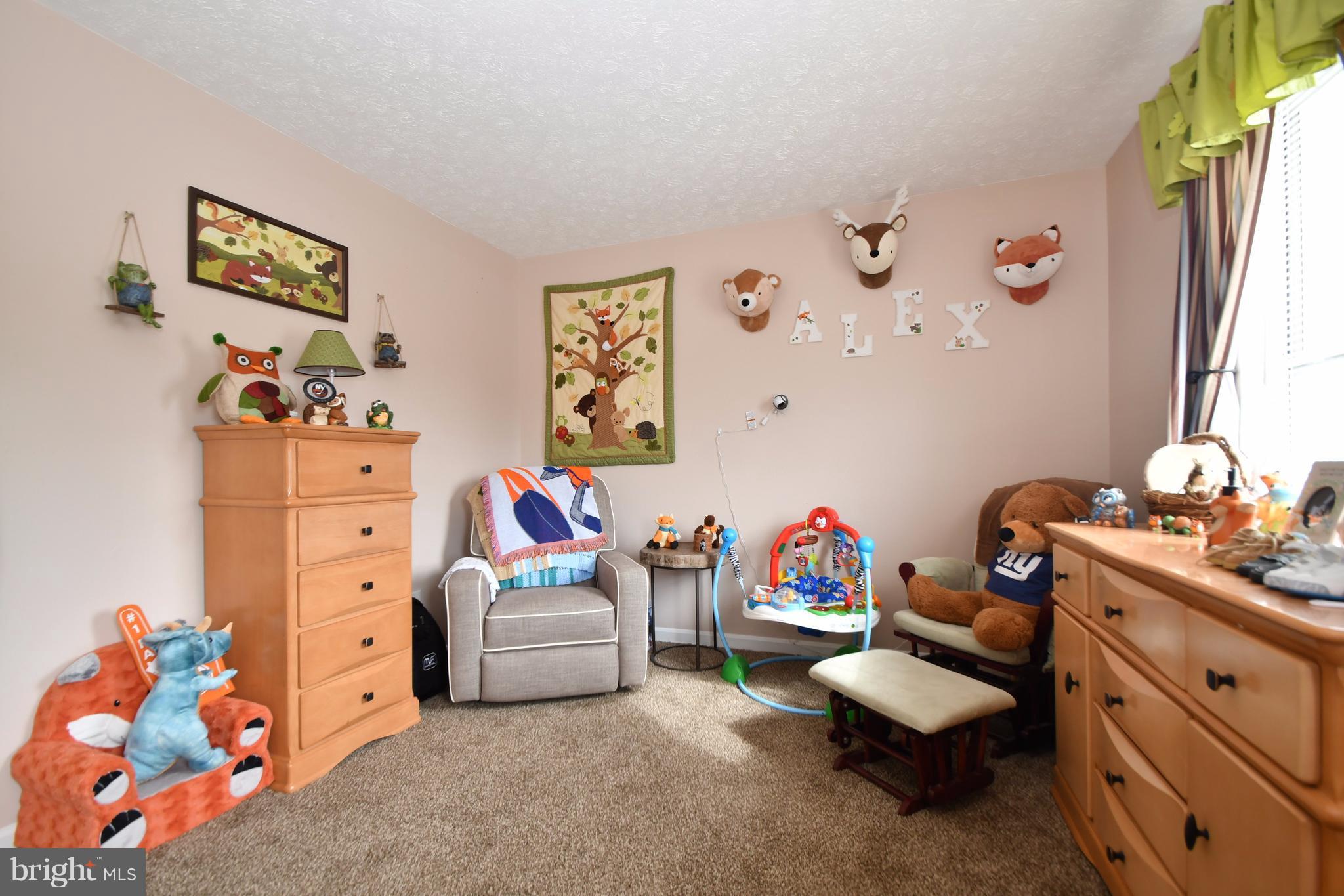 3924 Cutty Sark Road Baltimore, MD 21220 - Photo 23 of 30 a living room with furniture and a baby crib