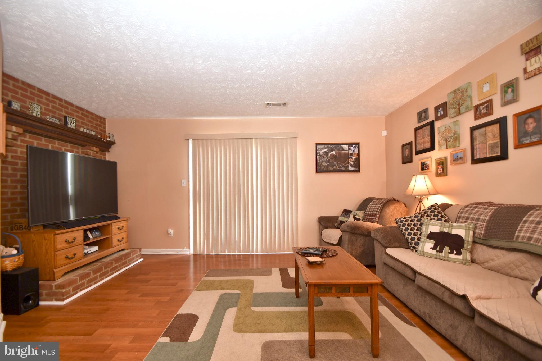3924 Cutty Sark Road Baltimore, MD 21220 - Photo 9 of 30 a living room with furniture and a flat screen tv