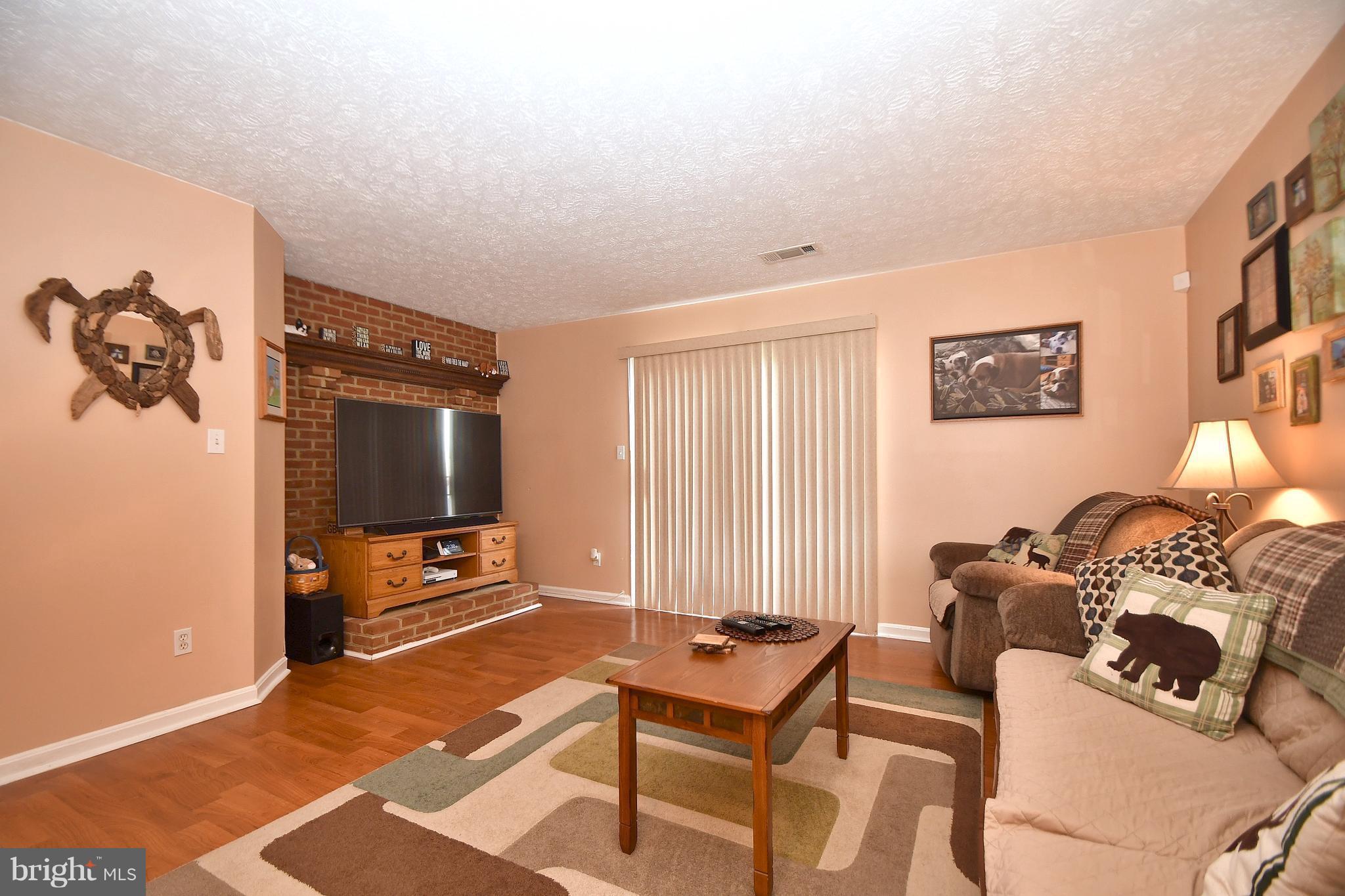 3924 Cutty Sark Road Baltimore, MD 21220 - Photo 10 of 30 a living room with furniture a flat screen tv and a window