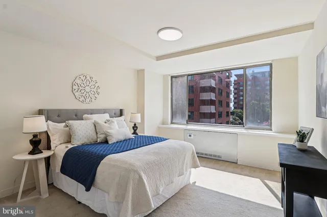 a bedroom with a bed and a window