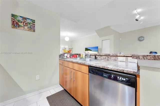 a kitchen with granite countertop a sink and cabinets