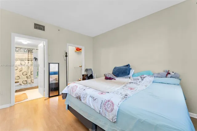 a bedroom with a bed and a painting on the wall