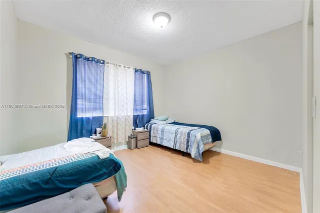 a bedroom with a bed and a night stand