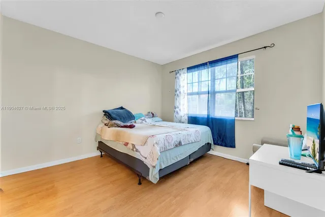 a spacious bedroom with a bed and a window