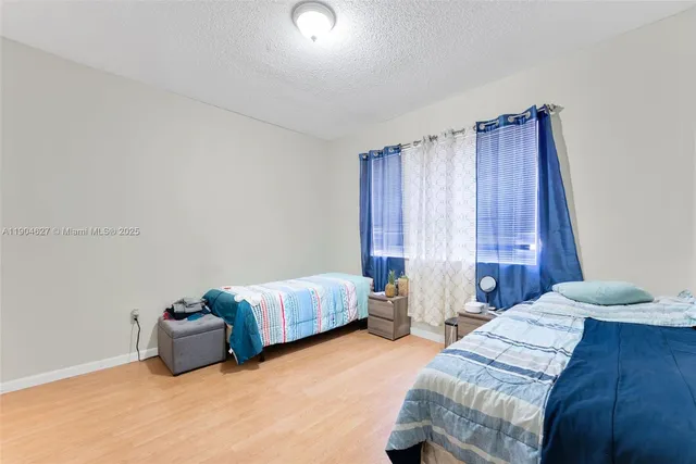 a bedroom with bed and window