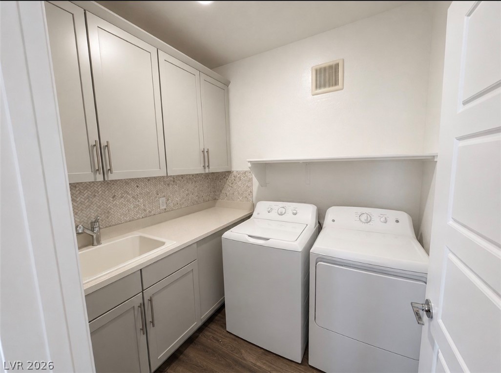 2555 Hampton Road, Unit 4205 Henderson, NV 89052 - Photo 22 of 52 Functional laundry room featuring a washer, dryer, and ample cabinet storage.