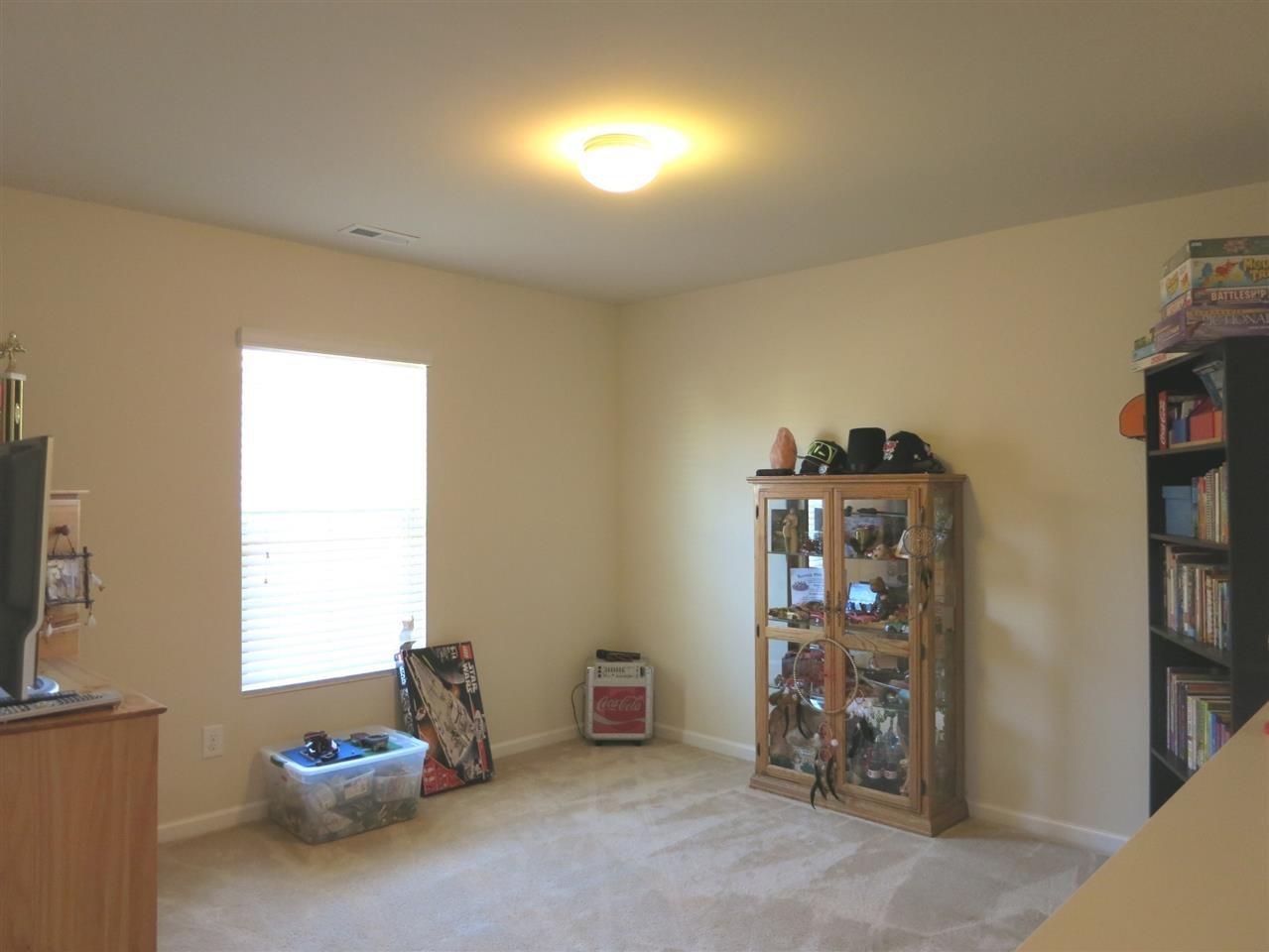3808 Althorp Drive Raleigh, NC 27616 - Photo 14 of 25 Upstairs, there is a Loft/Bonus Rm w/neutral carpet that is open to the staircase over a half wall.