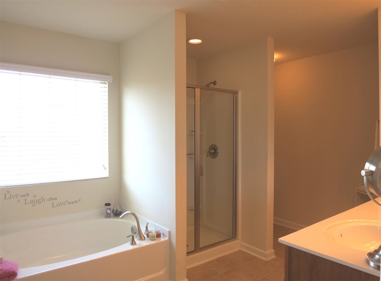 3808 Althorp Drive Raleigh, NC 27616 - Photo 18 of 25 The spacious Master Bath offers a soaking tub under a lg window, separate shower, neutral vinyl floor & double sinks.