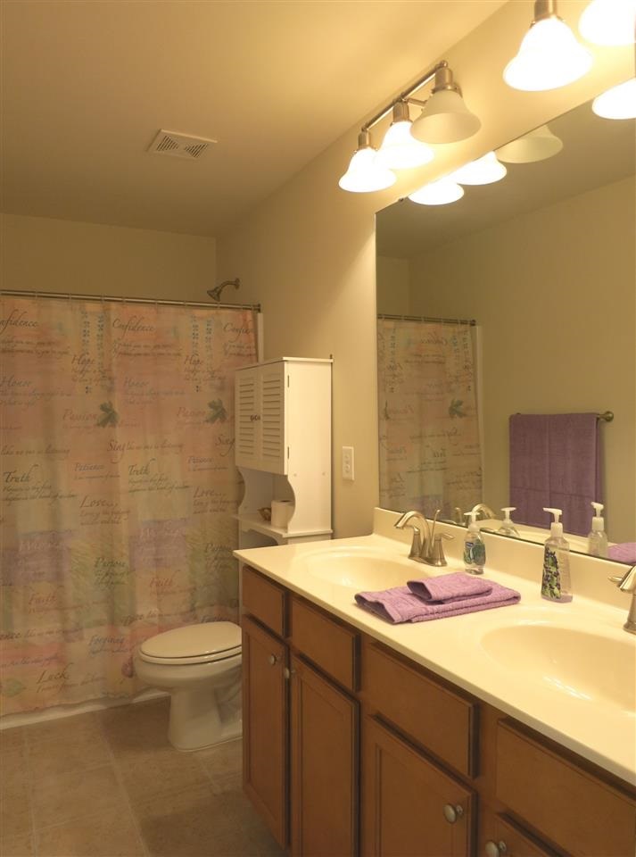 3808 Althorp Drive Raleigh, NC 27616 - Photo 21 of 25 View of the spacious family Bath w/neutral vinyl flr, dbl sinks & tub/shower.