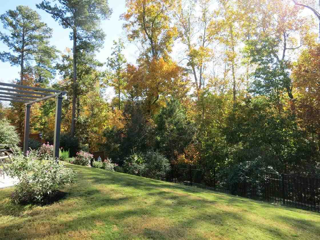 3808 Althorp Drive Raleigh, NC 27616 - Photo 23 of 25 The fenced and beautifully landscaped backyard backs to trees!