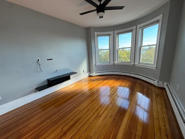 a view of room with window and wooden floor
