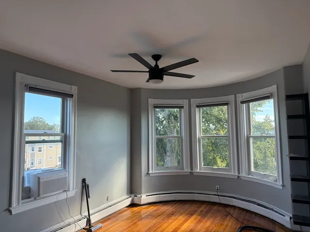a view of a livingroom with a ceiling fan and a window