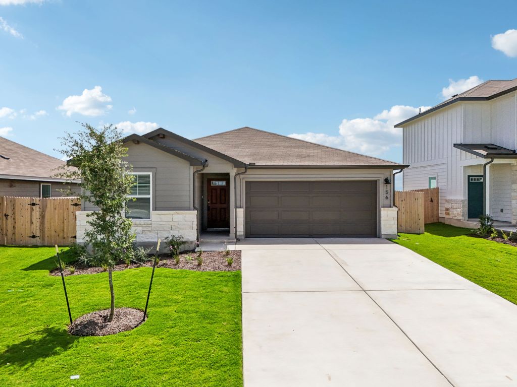 156 Honey Bee Road Jarrell, TX 76537 - Photo 1 of 1 View of front of home featuring an attached garage, stone siding, a shingled roof, concrete driveway, and a gate