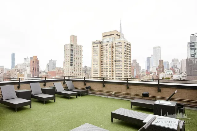 a view of swimming pool with outdoor seating and city view